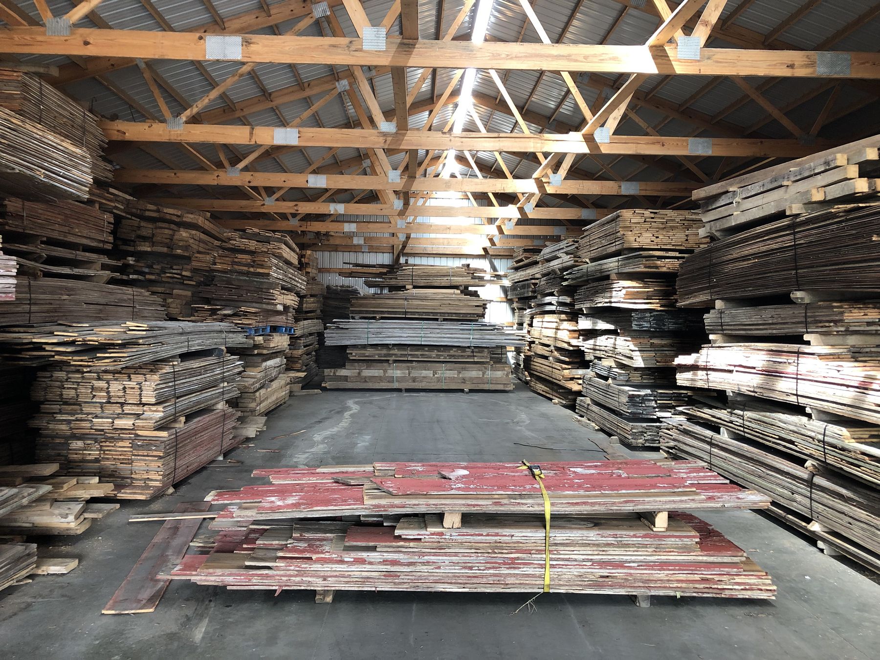 Reclaimed beams and boards stacked in the Revenant Timber yard
