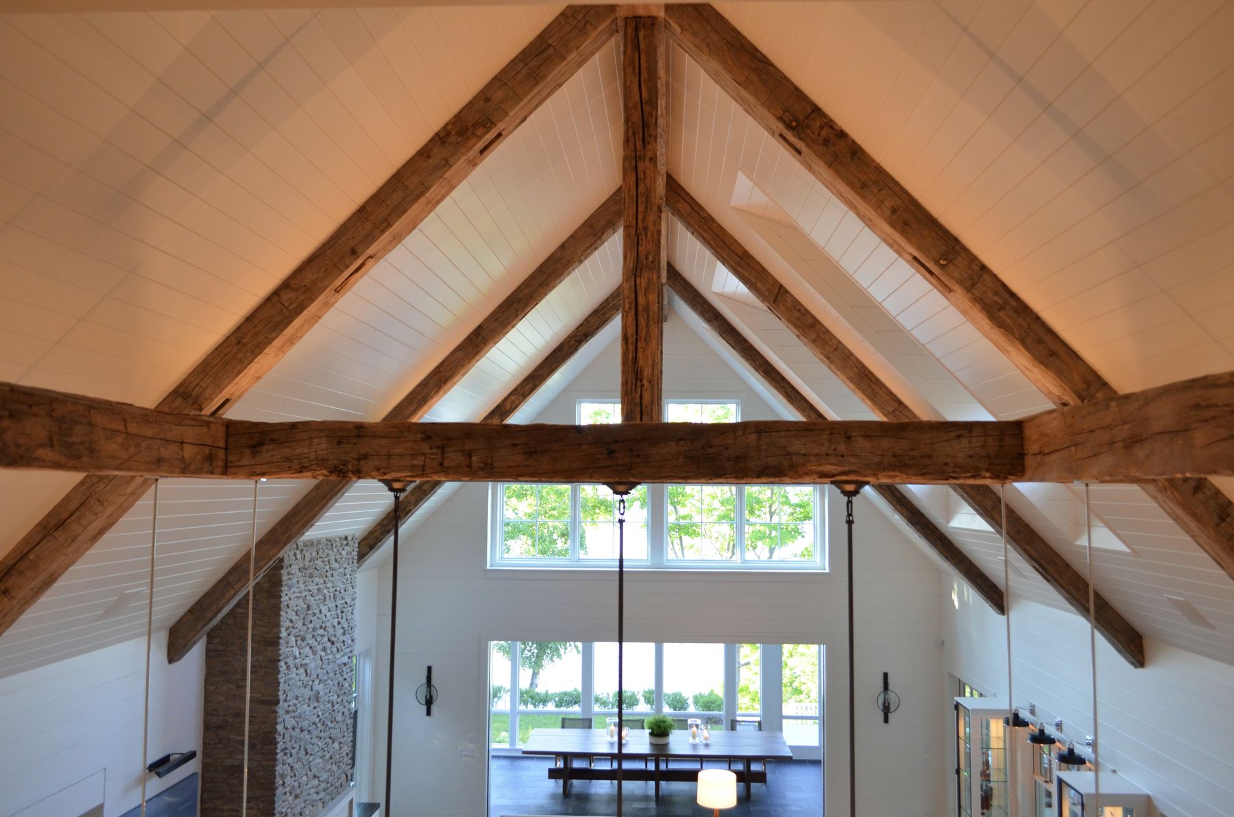 Hand-hewn reclaimed timber trusses in a vaulted ceiling