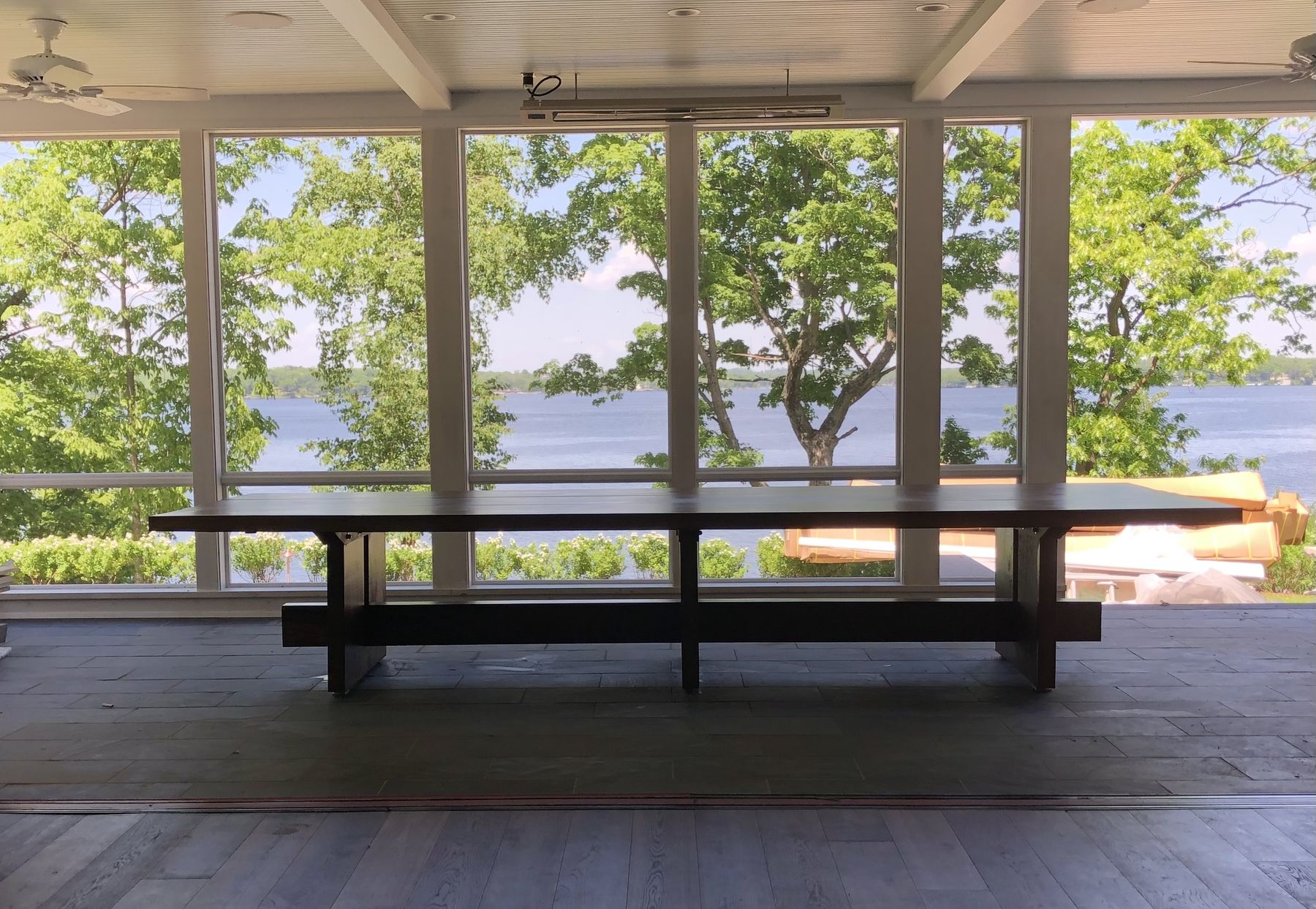A handbuilt reclaimed timber dining table overlooking the water